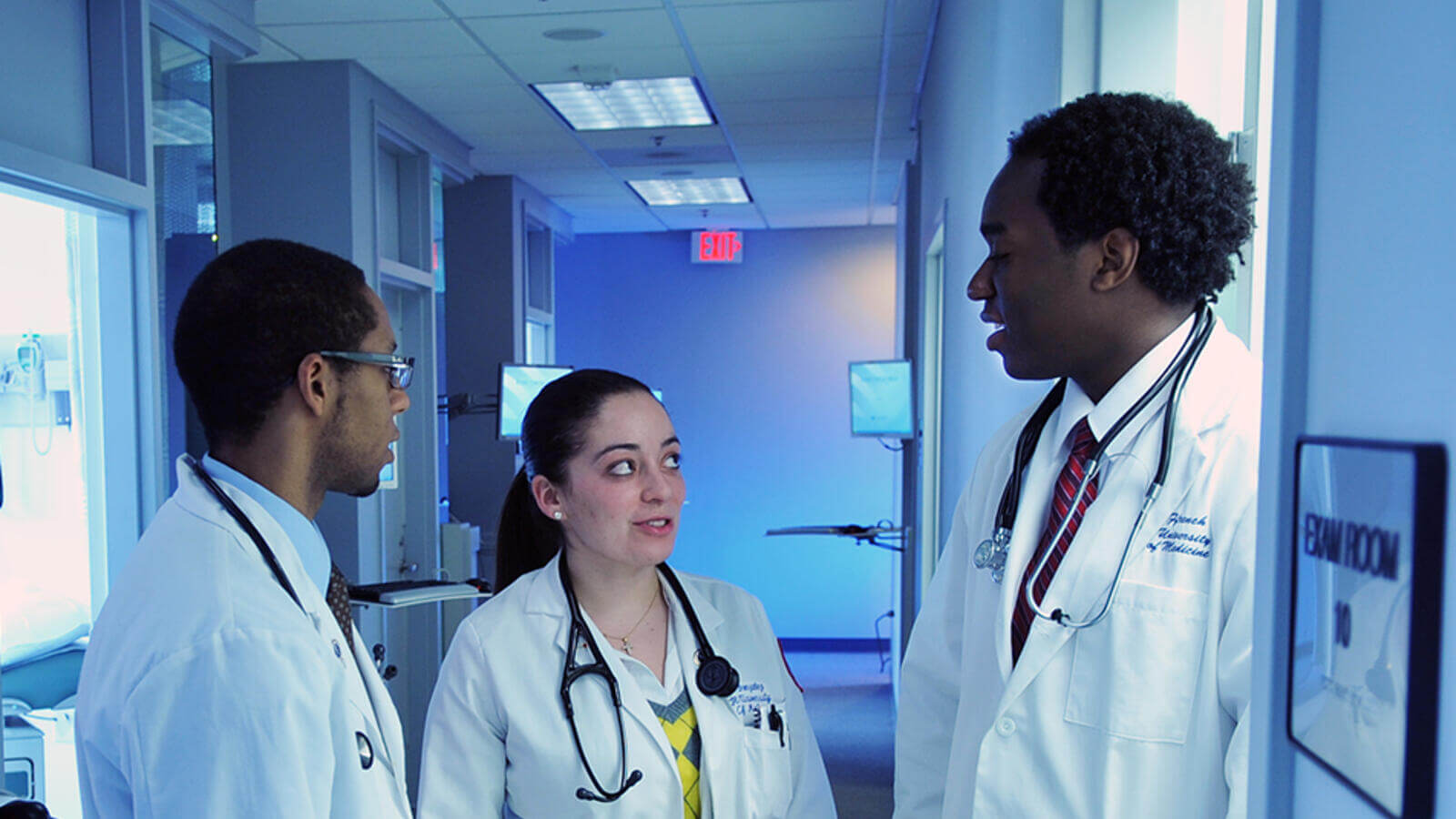 Doctors speaking in front of exam room