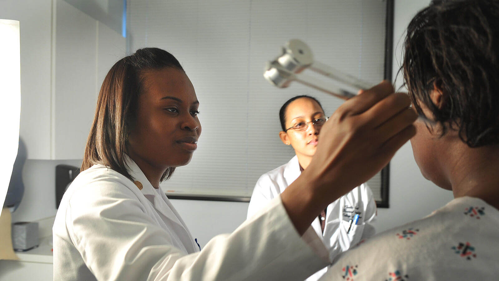 Doctor performing sound ear exam.