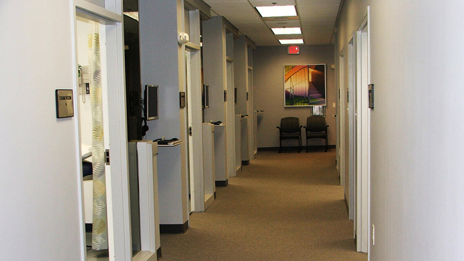 Two chairs at the end of a hallway