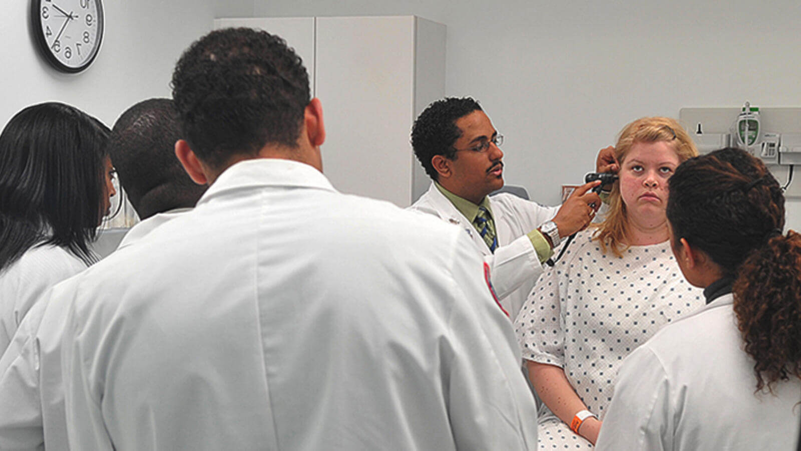 Faculty instructing group of students.