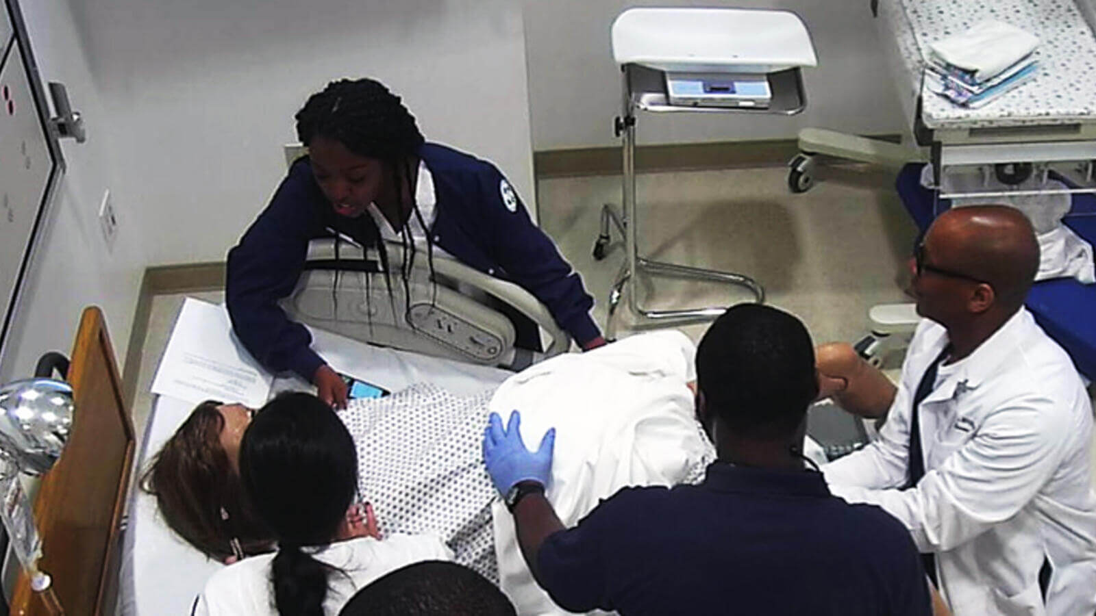 Nursing students in birthing practice.